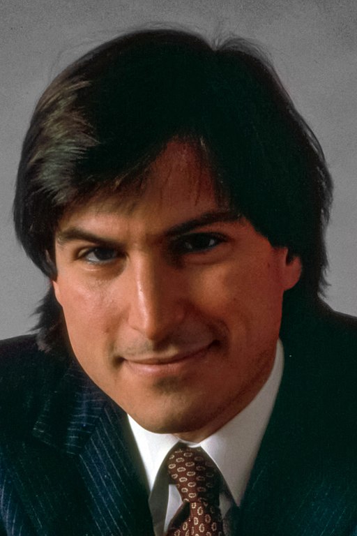 Steve Jobs in front of a Macintosh computer.