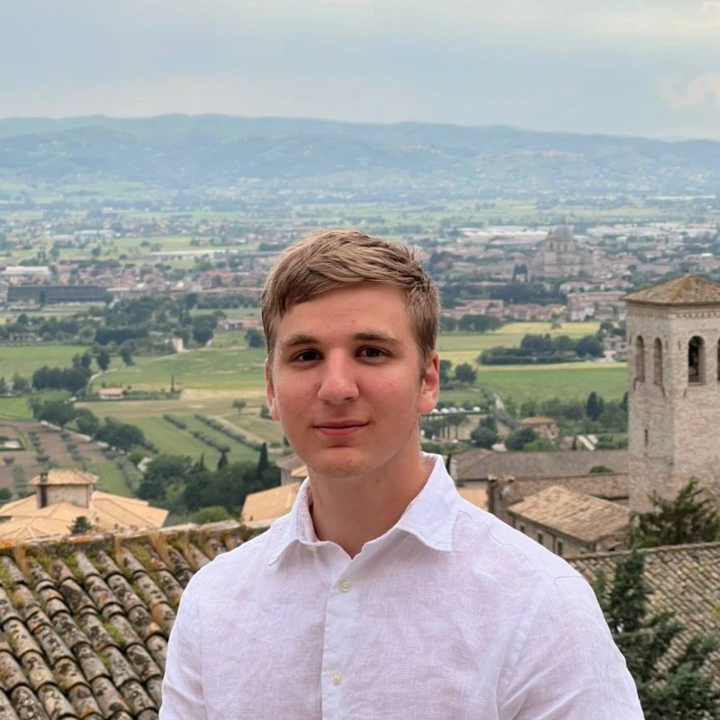 Adam Dauby with landscape behind.
