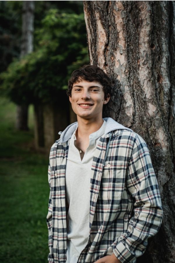 Matthew Olszewski in front of a tree.